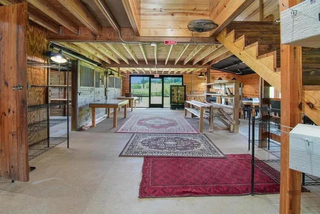 a dining room with furniture and a large window