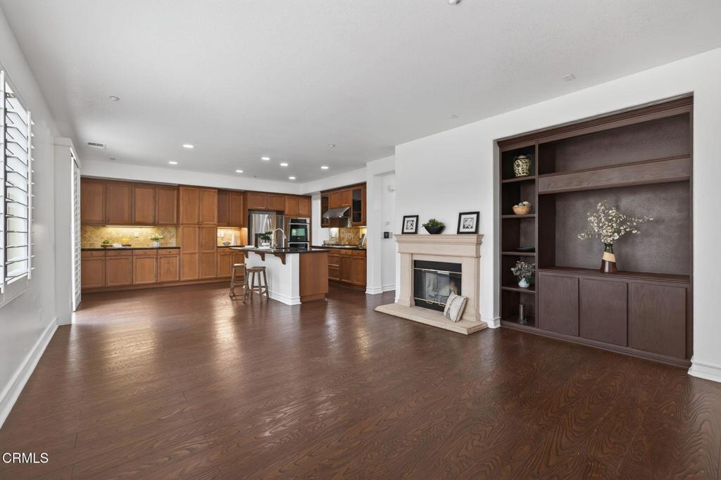 740 Freeport Lane Oxnard, CA 93035 - Photo 15 of 35 a view of open kitchen with wooden floor and a fireplace