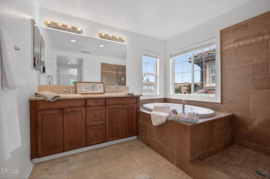 740 Freeport Lane Oxnard, CA 93035 - Photo 25 of 35 a spacious bathroom with a granite countertop tub sink and mirror
