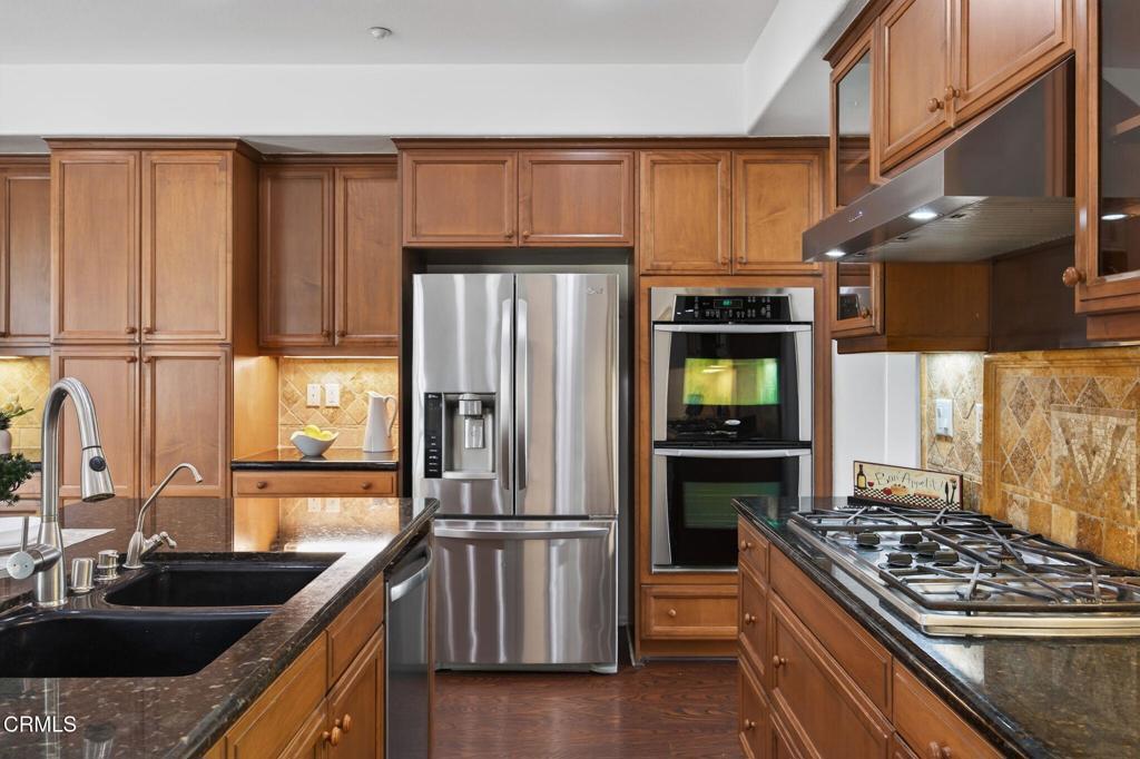 740 Freeport Lane Oxnard, CA 93035 - Photo 10 of 35 a kitchen with granite countertop a refrigerator stove and sink