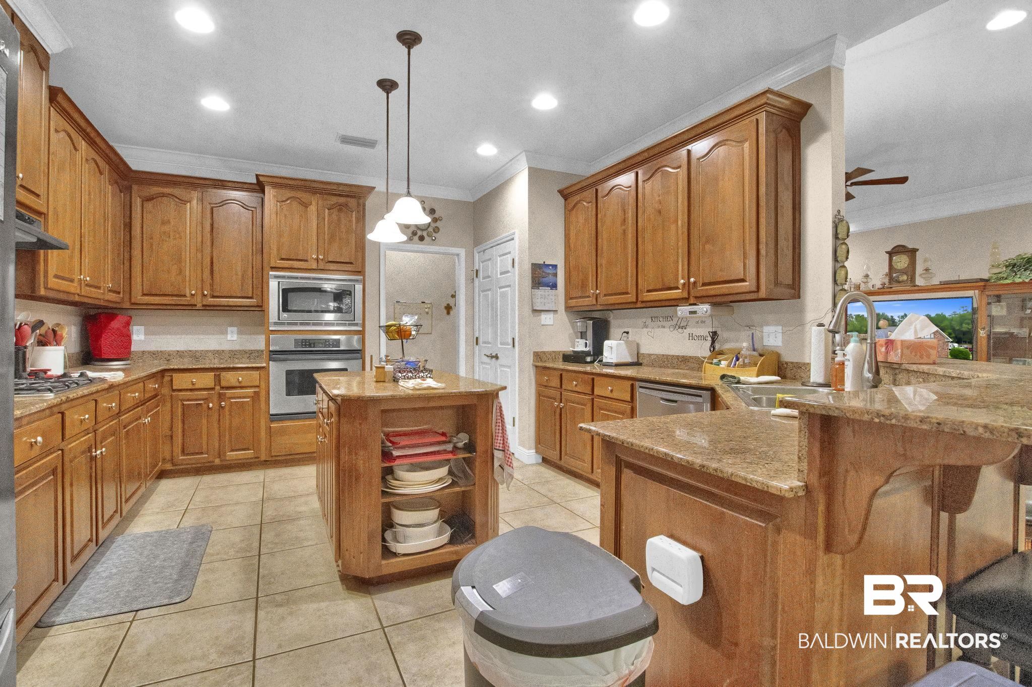 1 Bens Bluff Daphne, AL 36527 - Photo 17 of 56 Kitchen with a kitchen island, exhaust hood, appliances with stainless steel finishes, kitchen peninsula, and ceiling fan