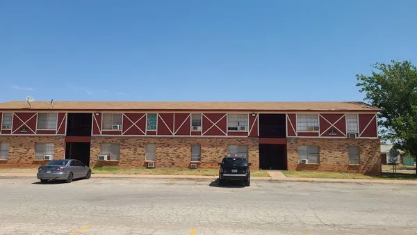 a front view of a house with parking space
