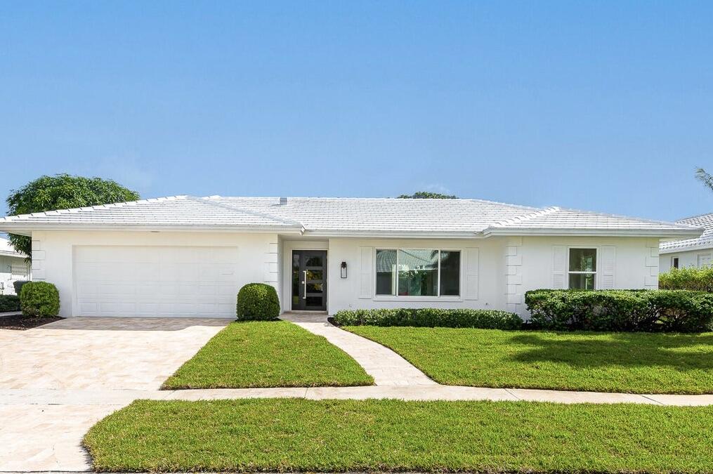 994 Walnut Terrace Boca Raton, FL 33486 - Photo 1 of 23 a view of a house with backyard and garden