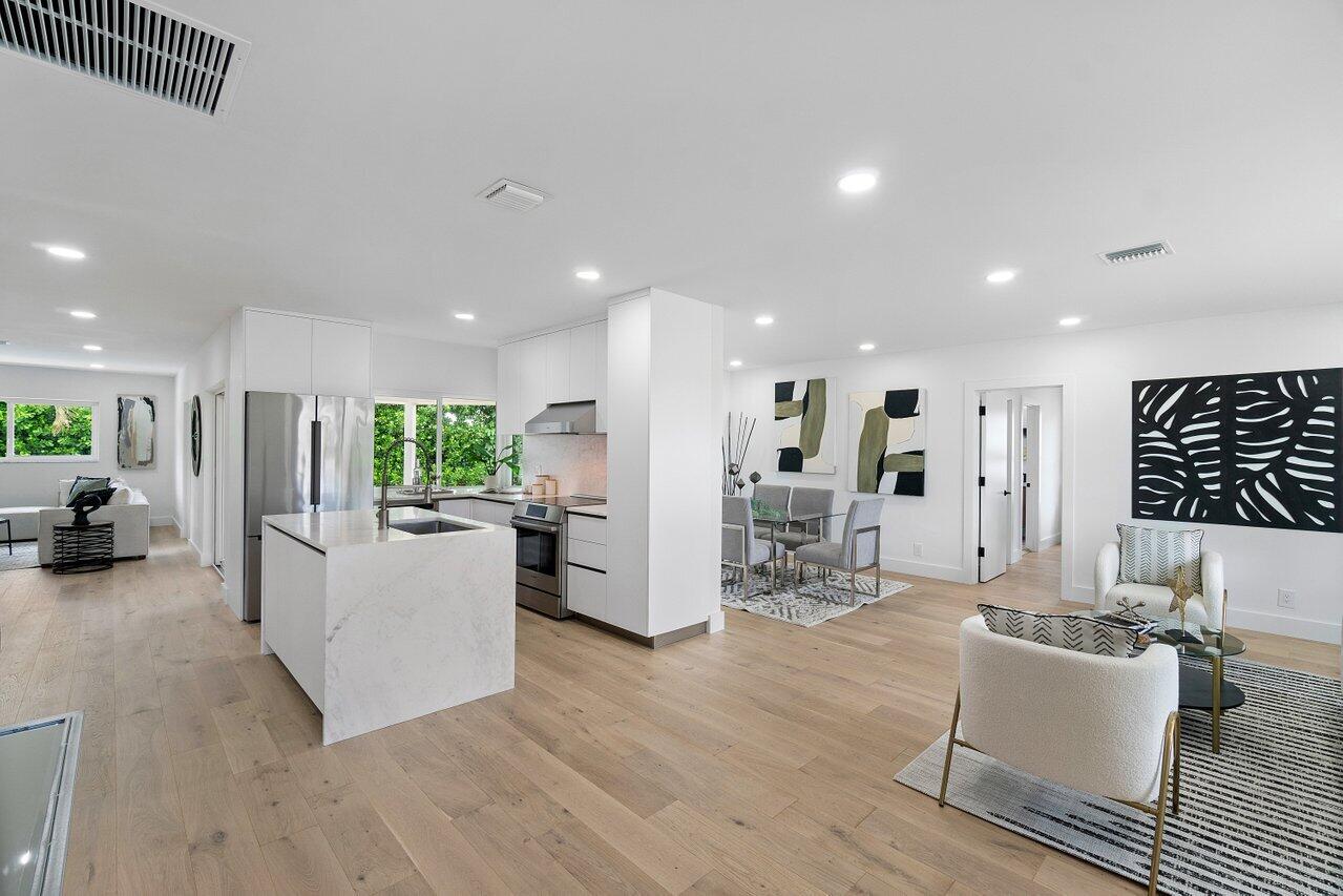 994 Walnut Terrace Boca Raton, FL 33486 - Photo 3 of 23 a living room kitchen with furniture and a wooden floor