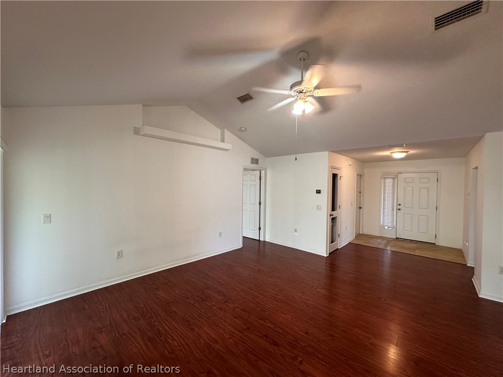 8737 Capilla Street Sebring, FL 33872 - Photo 15 of 43 a view of empty room with wooden floor
