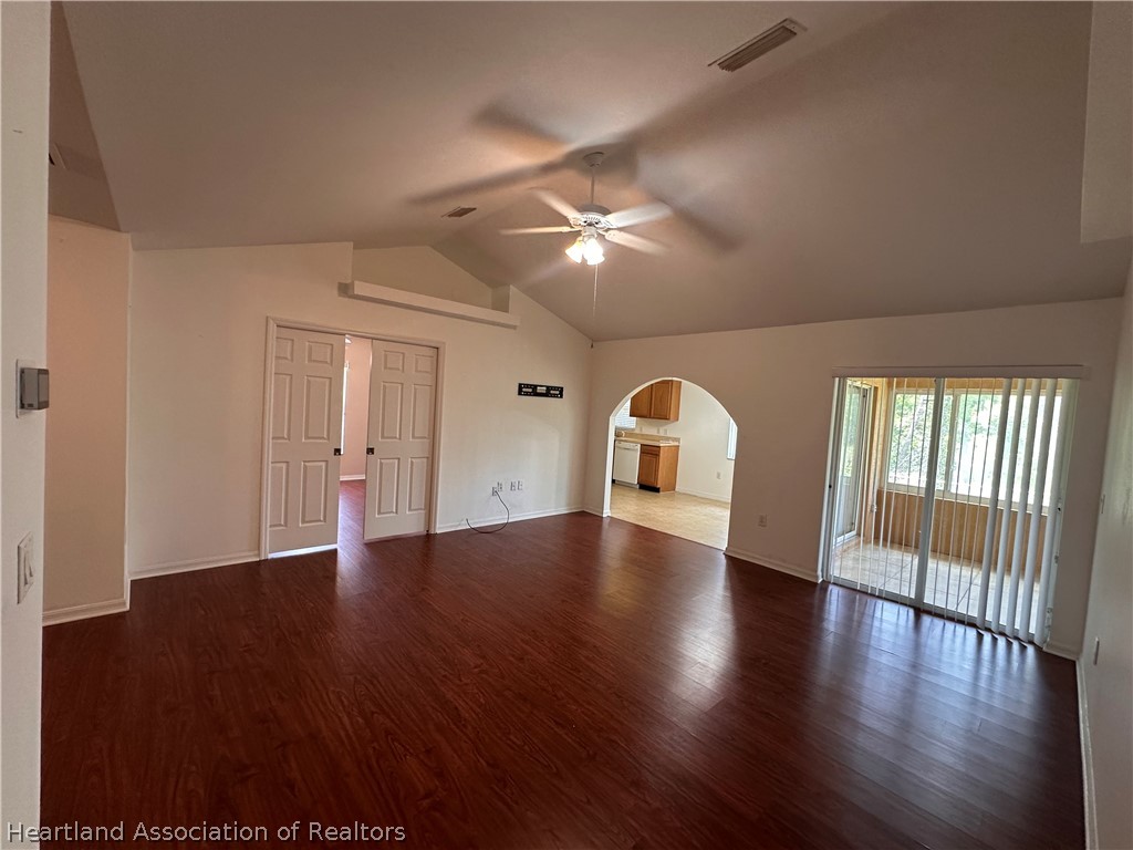 8737 Capilla Street Sebring, FL 33872 - Photo 17 of 43 a view of an empty room with a window and wooden floor