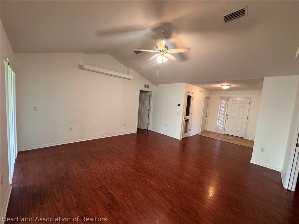 8737 Capilla Street Sebring, FL 33872 - Photo 19 of 43 a view of an empty room with wooden floor