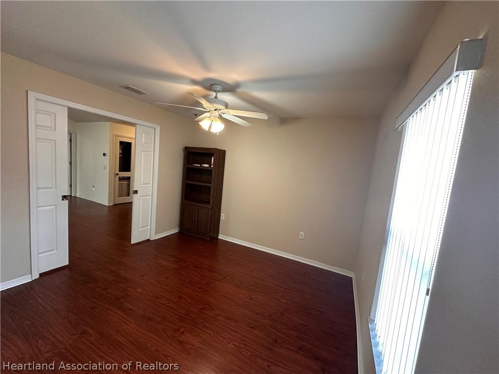 8737 Capilla Street Sebring, FL 33872 - Photo 21 of 43 an empty room with wooden floor and windows