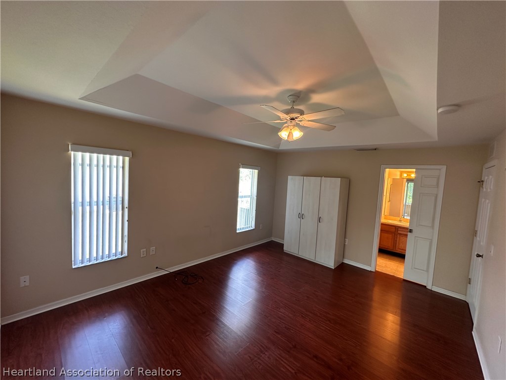 8737 Capilla Street Sebring, FL 33872 - Photo 23 of 43 a view of an empty room with wooden floor and fan