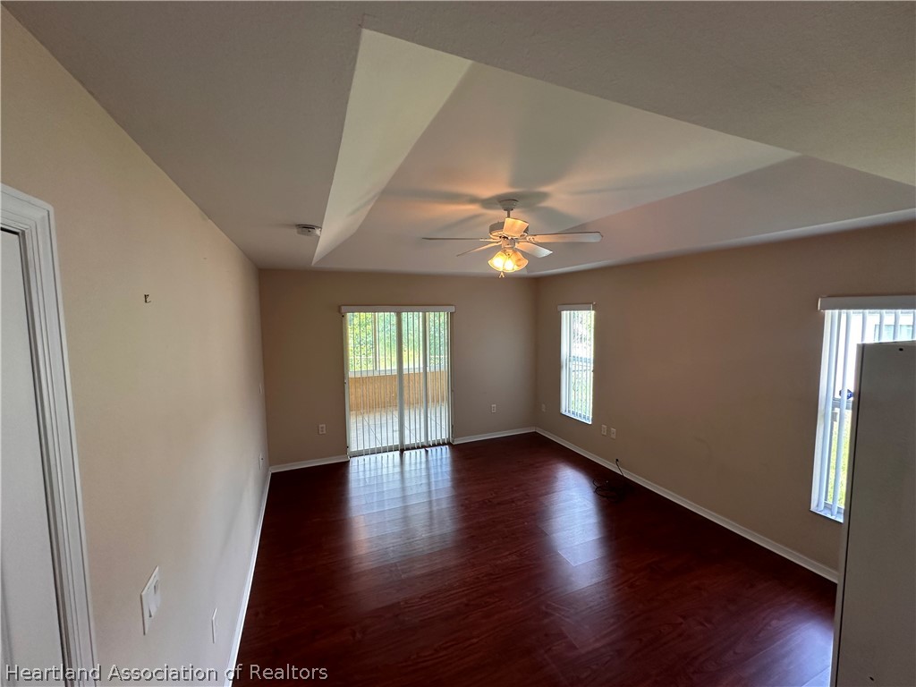 8737 Capilla Street Sebring, FL 33872 - Photo 24 of 43 a view of an empty room with wooden floor and a window