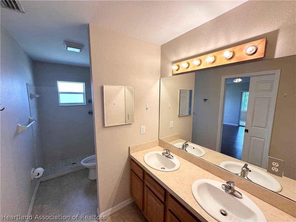 8737 Capilla Street Sebring, FL 33872 - Photo 28 of 43 a bathroom with a sink and a mirror