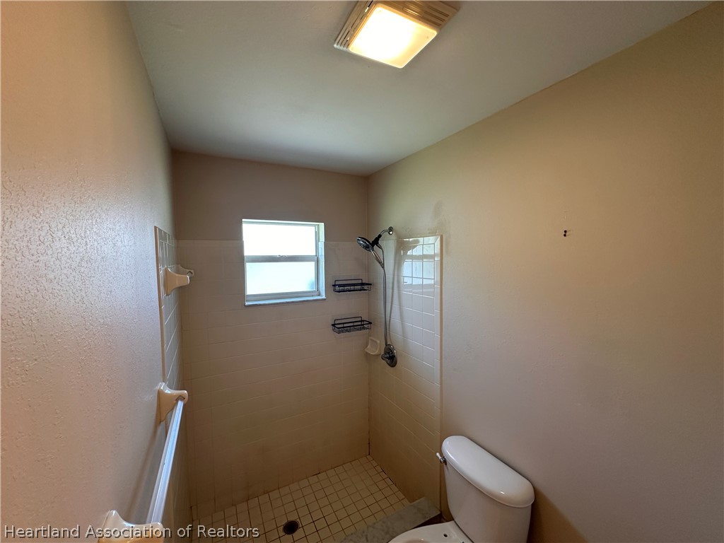 8737 Capilla Street Sebring, FL 33872 - Photo 29 of 43 a bathroom with a toilet and a shower