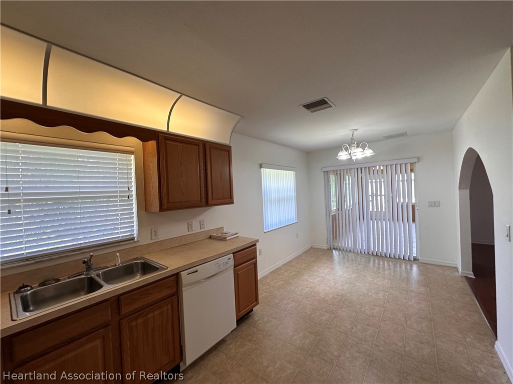 8737 Capilla Street Sebring, FL 33872 - Photo 8 of 43 a kitchen that has a sink and a stove