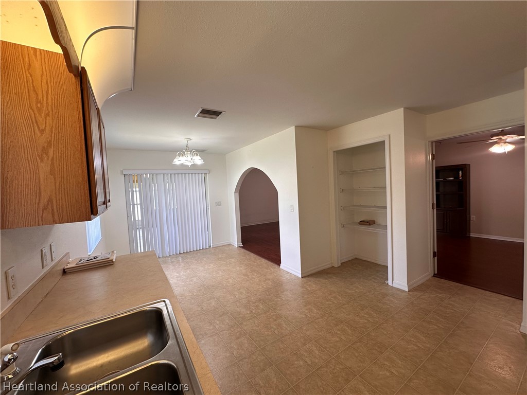 8737 Capilla Street Sebring, FL 33872 - Photo 10 of 43 a room with a couch and a sink