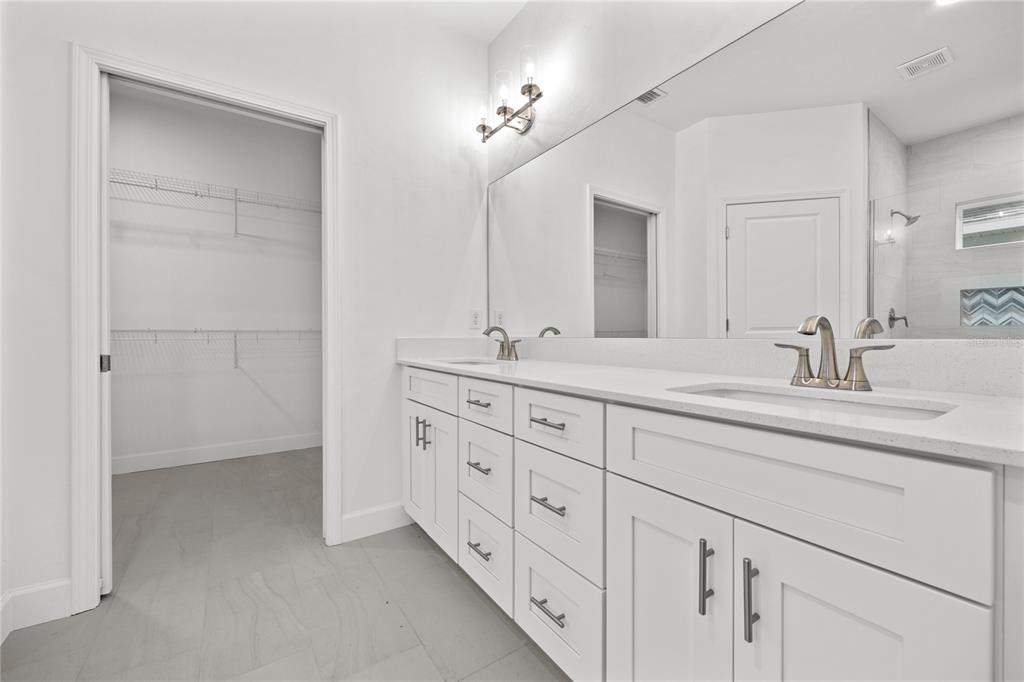 1086 Southwest 67th Drive Gainesville, FL 32607 - Photo 12 of 37 a bathroom with double sink and a mirror