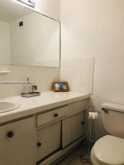 100 Lincoln Road, Unit 541 Miami Beach, FL 33139 - Photo 5 of 7 a bathroom with a sink and a toilet