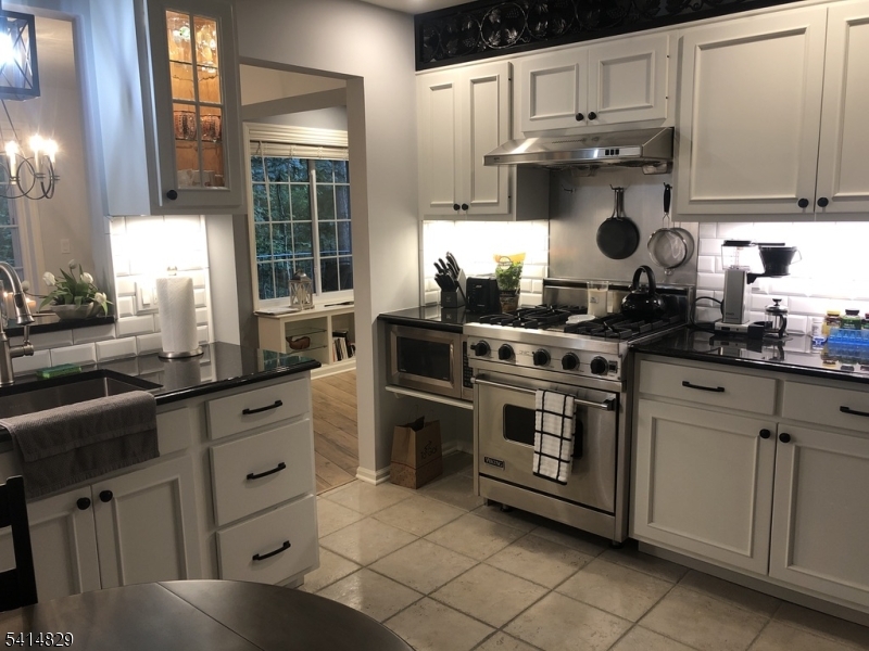 173 Riveredge Drive Chatham, NJ 07928 - Photo 4 of 11 a kitchen with stainless steel appliances granite countertop a sink stove and cabinets