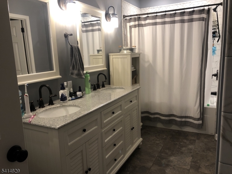 173 Riveredge Drive Chatham, NJ 07928 - Photo 5 of 11 a bathroom with a granite countertop sink and a mirror