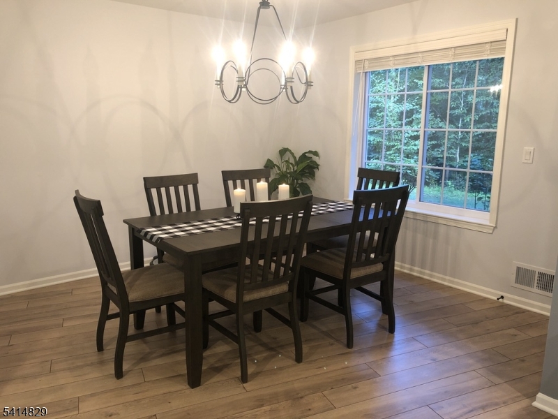 173 Riveredge Drive Chatham, NJ 07928 - Photo 8 of 11 a view of a dining room with furniture window and wooden floor