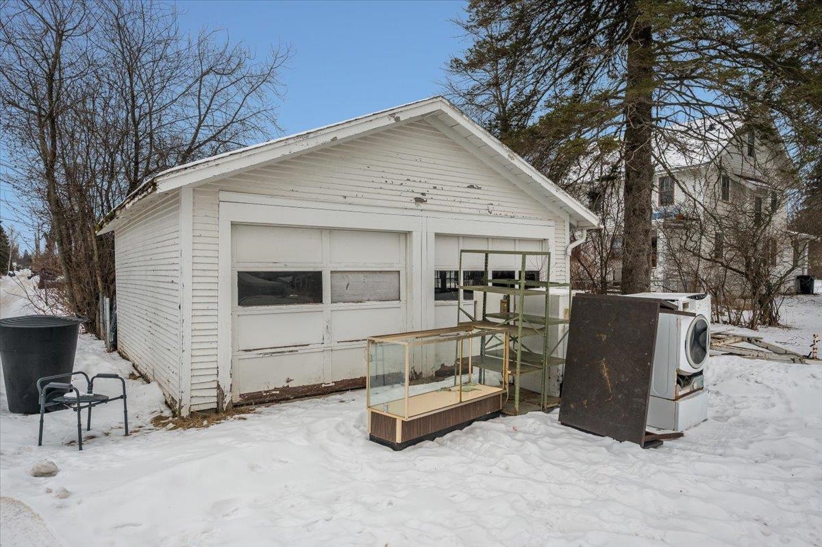 701 East 4th Street Superior, WI 54880 - Photo 16 of 16 Snow covered back of property featuring an outbuilding and a deck