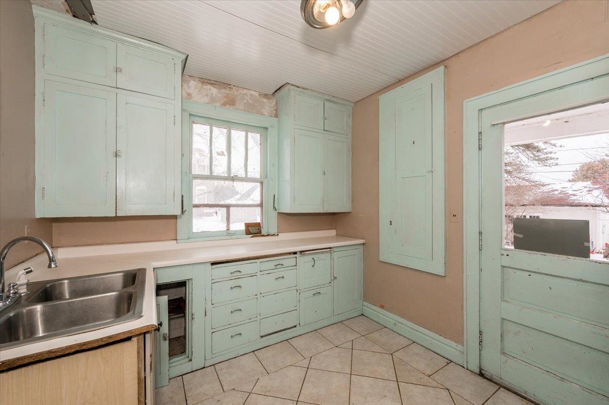 701 East 4th Street Superior, WI 54880 - Photo 5 of 16 Kitchen with green cabinetry, light countertops, and light tile patterned floors