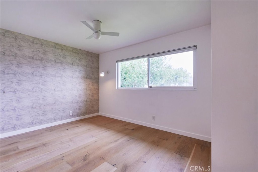 345 Broadway Costa Mesa, CA 92627 - Photo 12 of 20 an empty room with wooden floor and windows