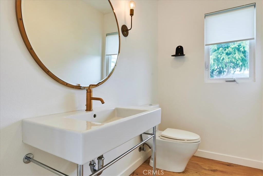 345 Broadway Costa Mesa, CA 92627 - Photo 15 of 20 a bathroom with a sink a toilet and a mirror