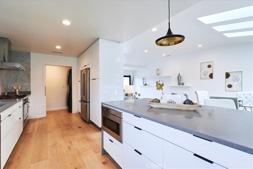 345 Broadway Costa Mesa, CA 92627 - Photo 6 of 20 a kitchen with kitchen island a counter space a sink and appliances