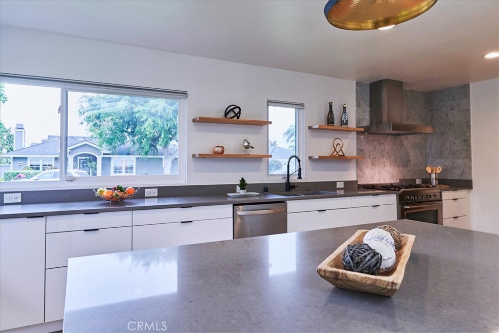 345 Broadway Costa Mesa, CA 92627 - Photo 8 of 20 a kitchen with stainless steel appliances granite countertop a stove a sink and a microwave