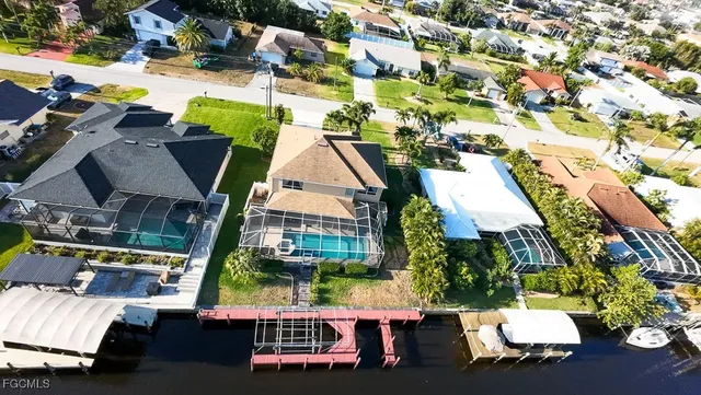 an aerial view of a house with a swimming pool