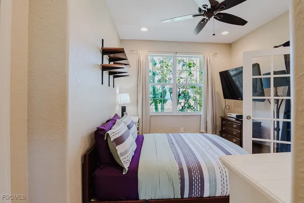 a bedroom with a bed and a flat screen tv