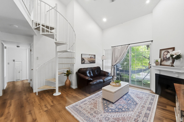 650 South Main Street, Unit 3304 Bountiful, UT 84010 - Photo 4 of 22 Living space featuring a white spiral staircase, vaulted ceilings, and wood-finish flooring