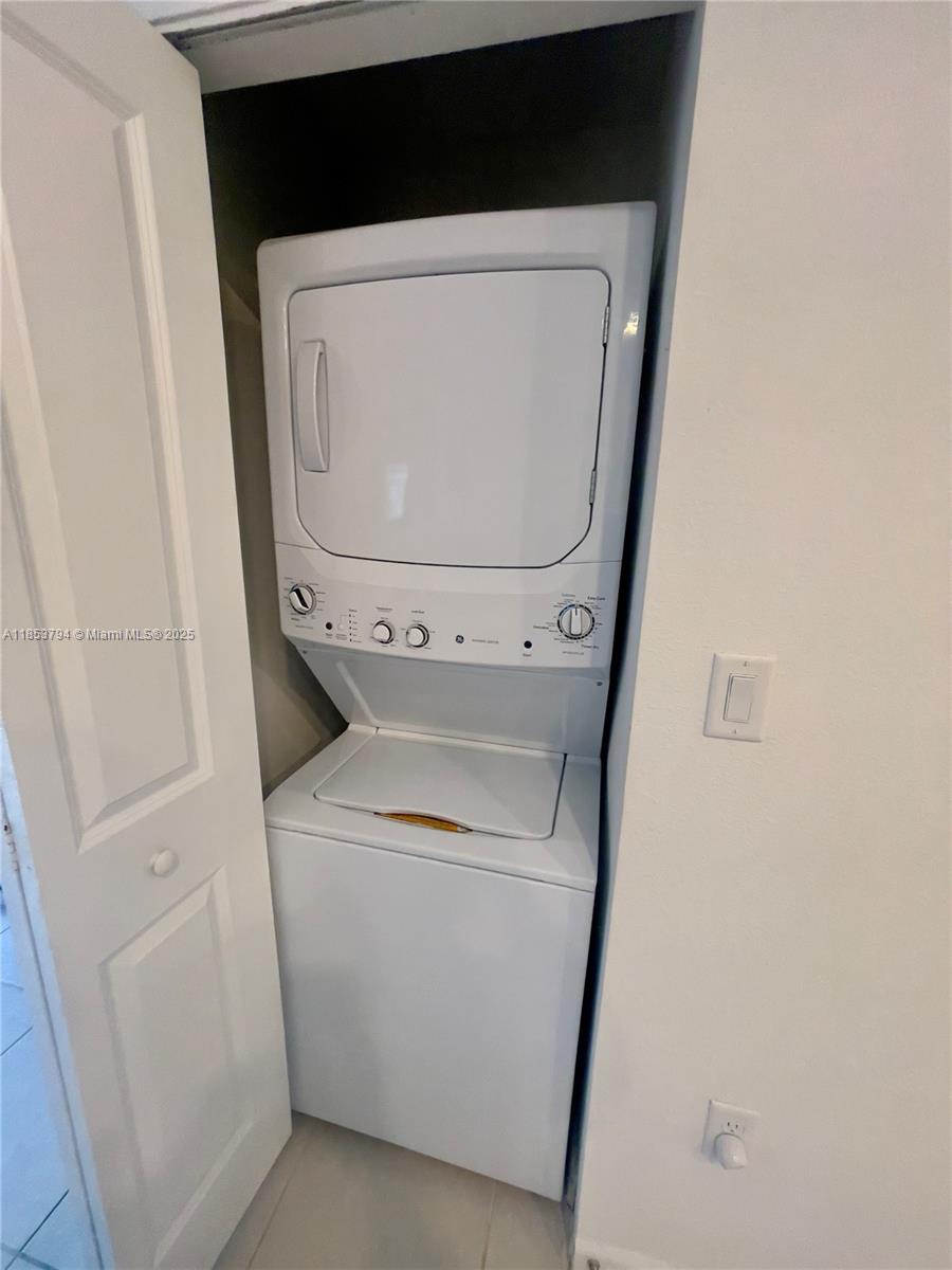 10005 Southwest 228th Terrace, Unit 10005 Miami, FL 33190 - Photo 12 of 12 a close up view of a washer and dryer