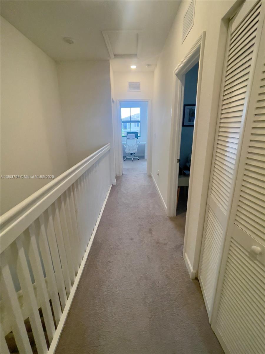 10005 Southwest 228th Terrace, Unit 10005 Miami, FL 33190 - Photo 5 of 12 a view of hallway with stairs