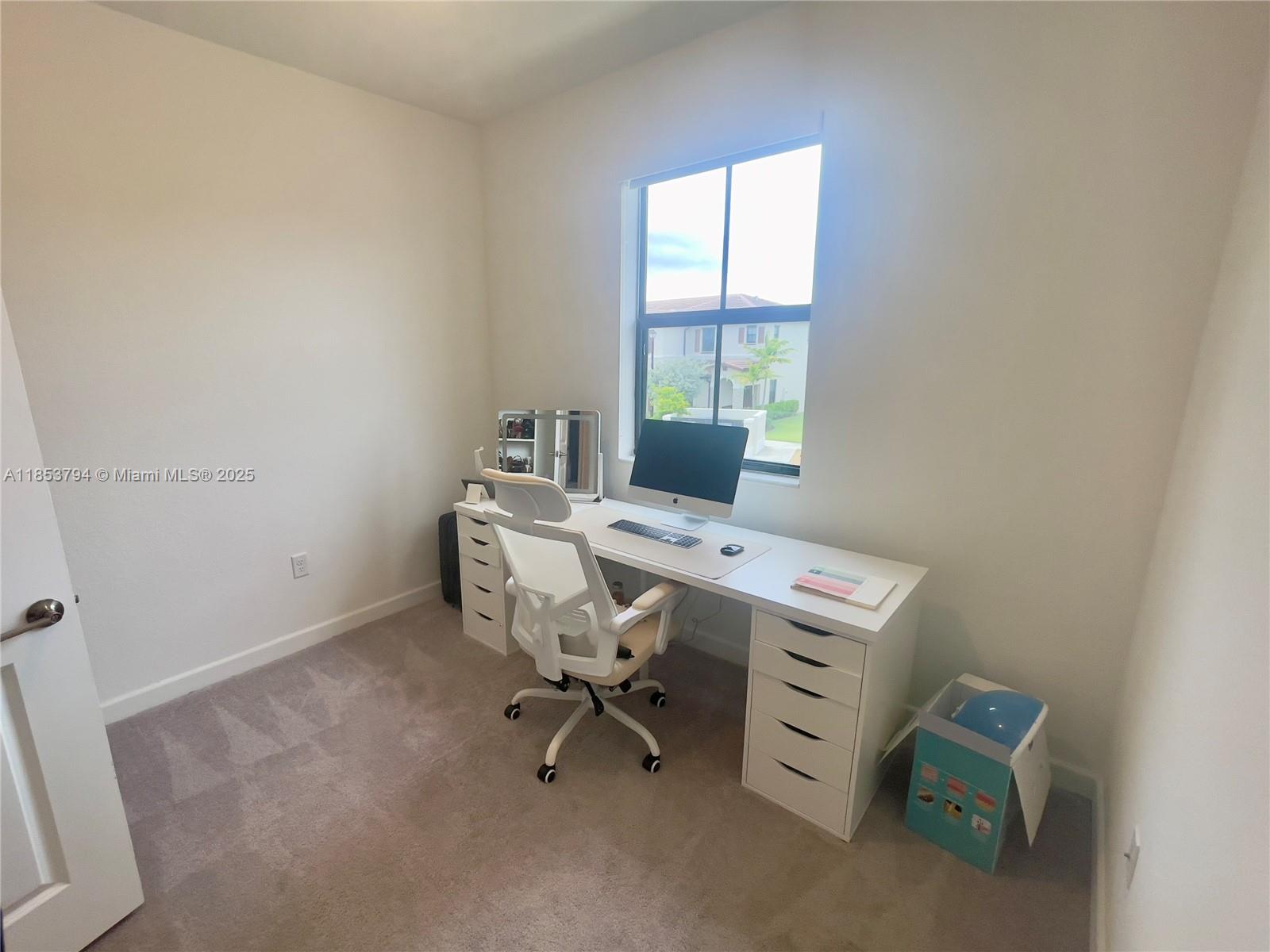 10005 Southwest 228th Terrace, Unit 10005 Miami, FL 33190 - Photo 8 of 12 a view of a workspace with furniture and a window