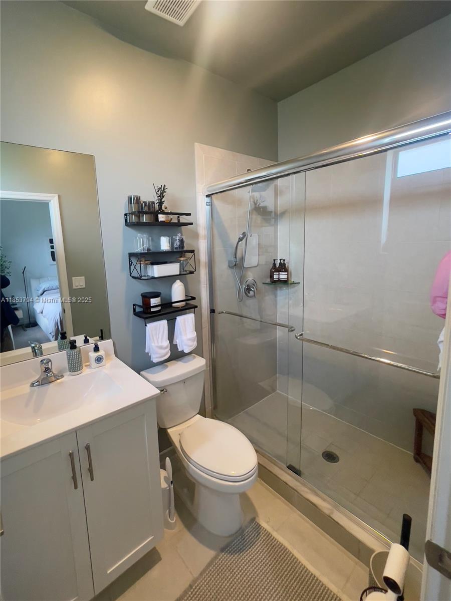 10005 Southwest 228th Terrace, Unit 10005 Miami, FL 33190 - Photo 10 of 12 a bathroom with a sink toilet and shower