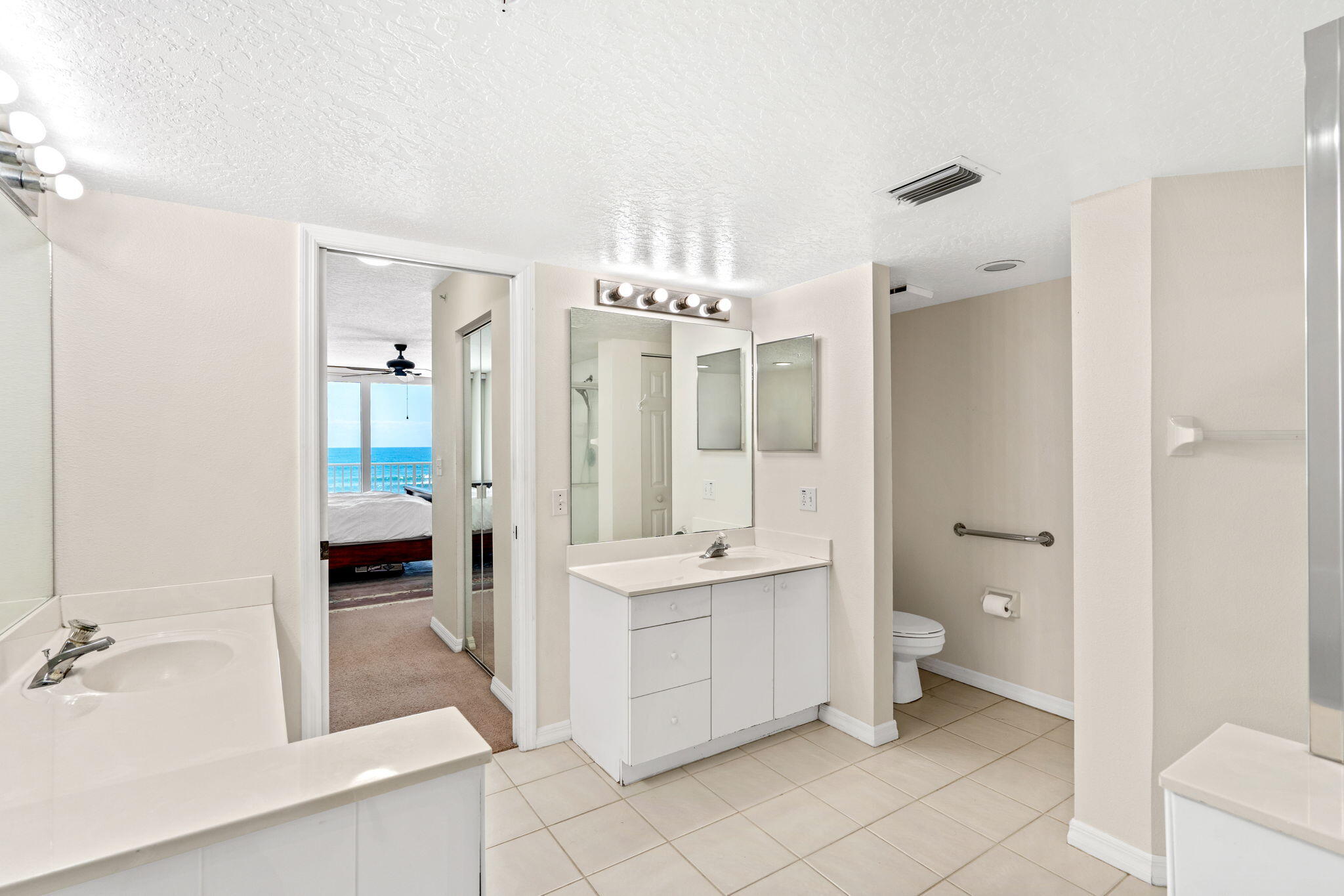 1505 North Hwy A1A, Unit 304 Indialantic, FL 32903 - Photo 12 of 27 a spacious bathroom with a shower sink and mirror