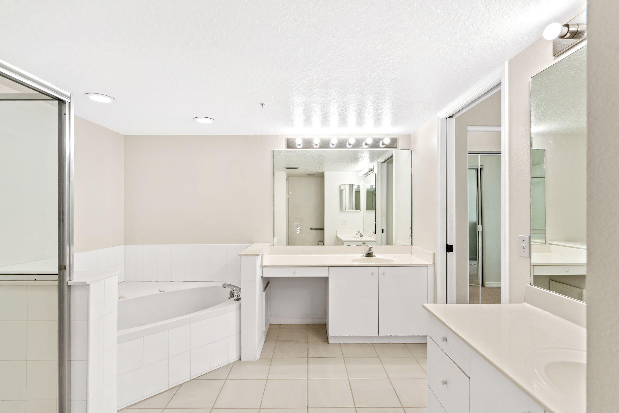 1505 North Hwy A1A, Unit 304 Indialantic, FL 32903 - Photo 13 of 27 a bathroom with a tub sink shower and mirror