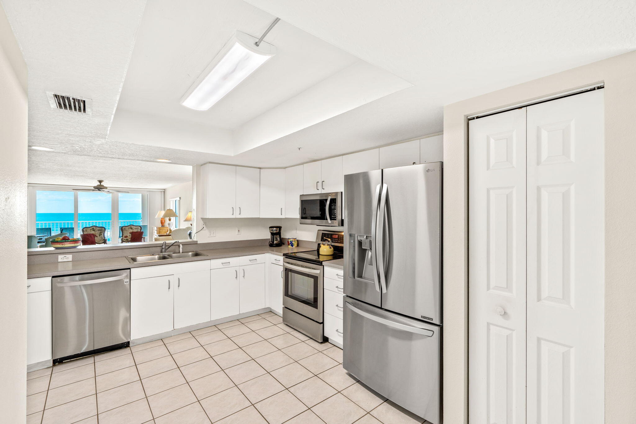 1505 North Hwy A1A, Unit 304 Indialantic, FL 32903 - Photo 7 of 27 a kitchen with white cabinets and stainless steel appliances