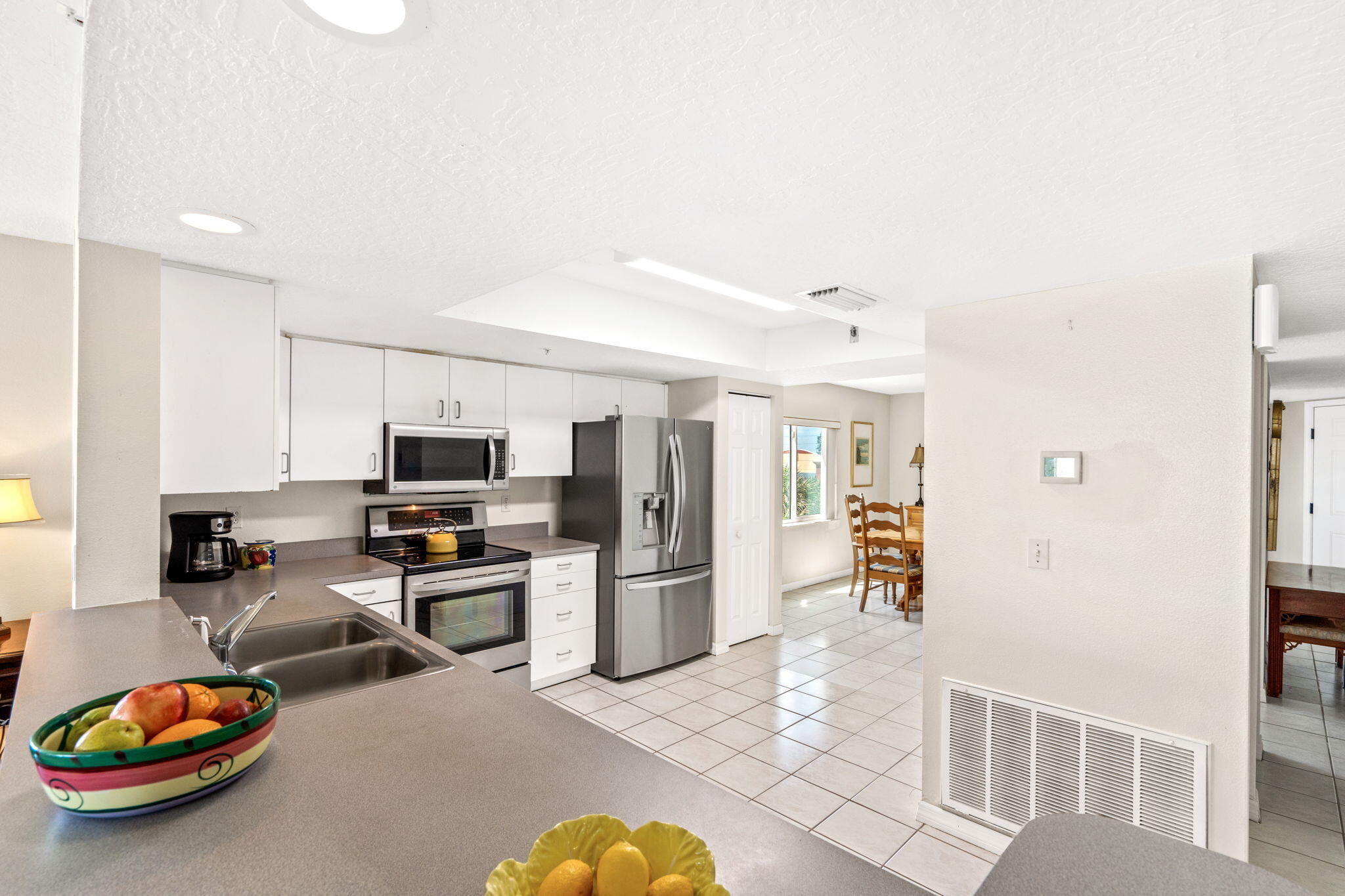 1505 North Hwy A1A, Unit 304 Indialantic, FL 32903 - Photo 8 of 27 a kitchen with stainless steel appliances a refrigerator and a stove top oven