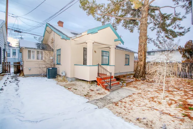 a outdoor space with the couches and white kitchen view
