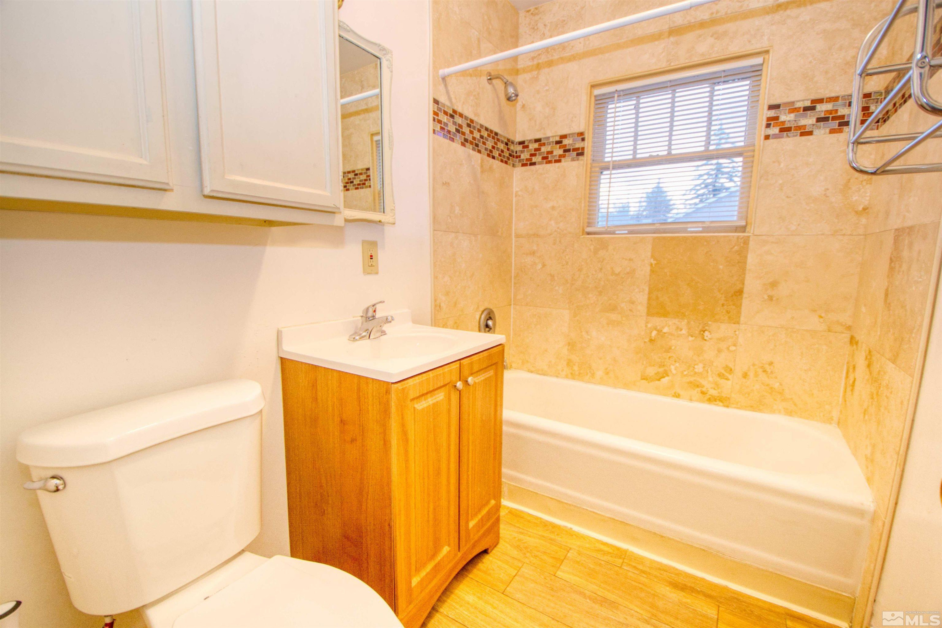 829 Plumas Street, Unit C Reno, NV 89509 - Photo 12 of 12 a bathroom with a sink mirror vanity and toilet