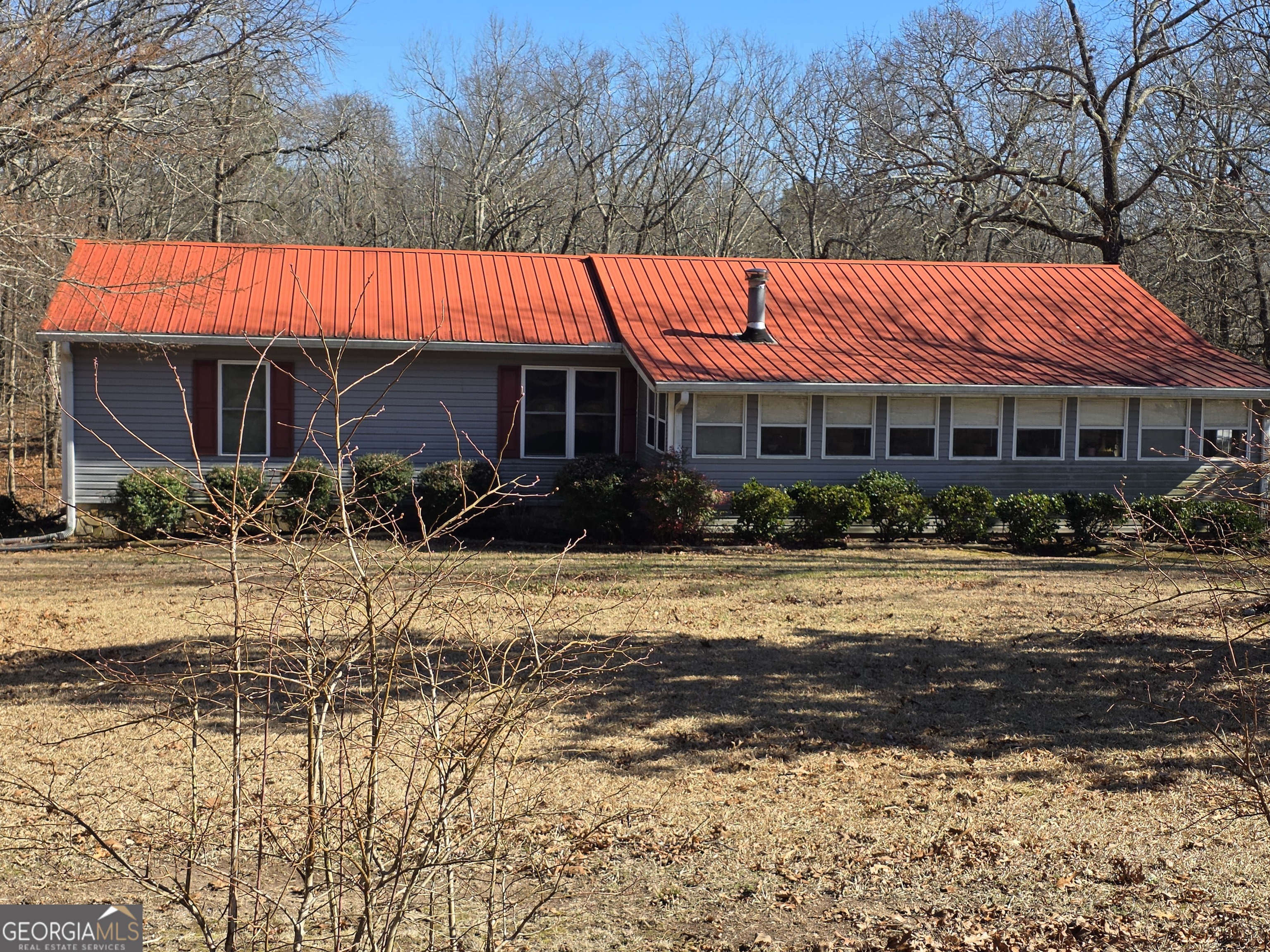 3879 Caney Head Road Roopville, GA 30217 - Photo 1 of 64 a view of a house with a yard covered with snow in the background