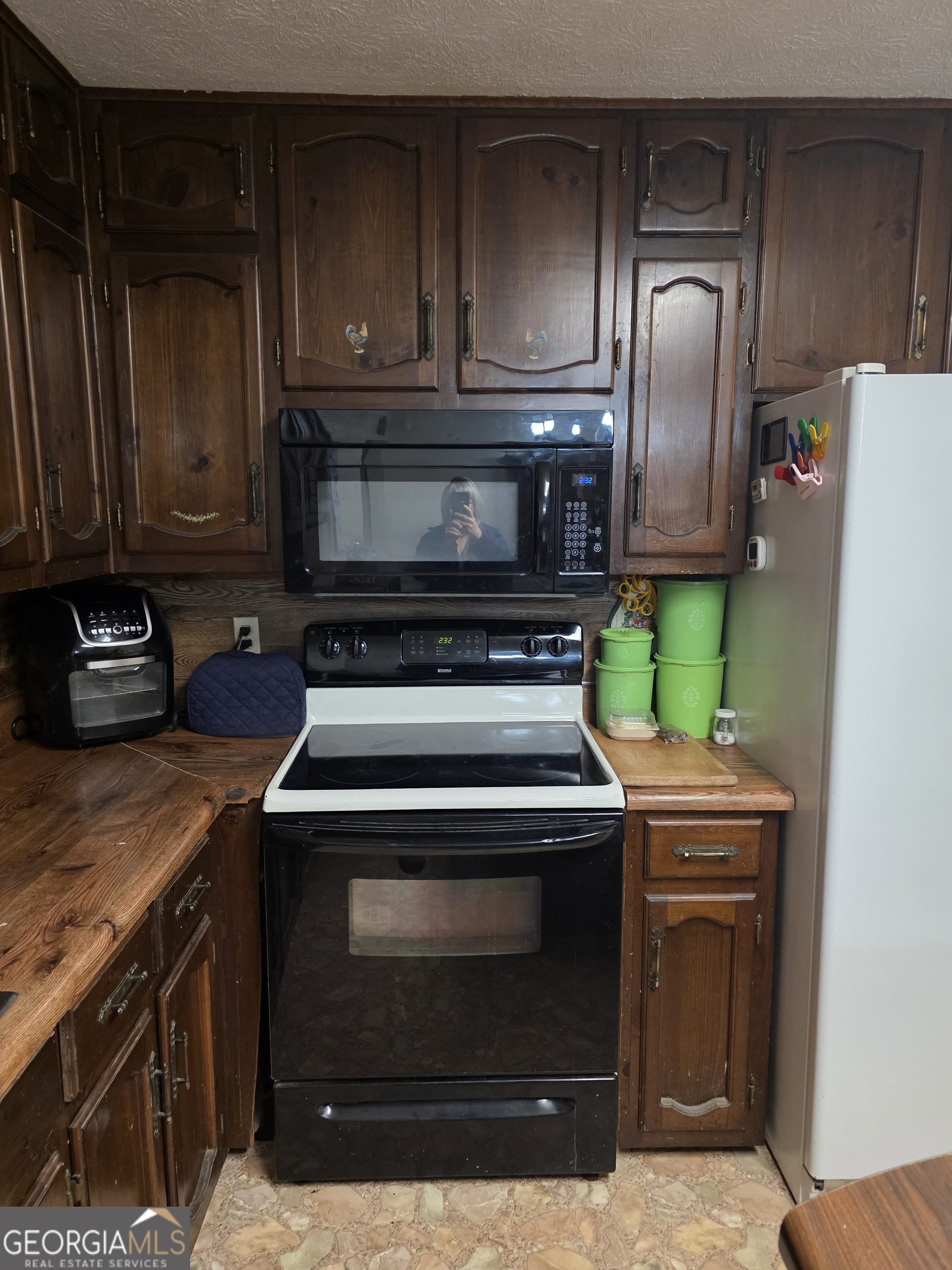 3879 Caney Head Road Roopville, GA 30217 - Photo 22 of 64 a kitchen with wooden cabinets and stainless steel appliances