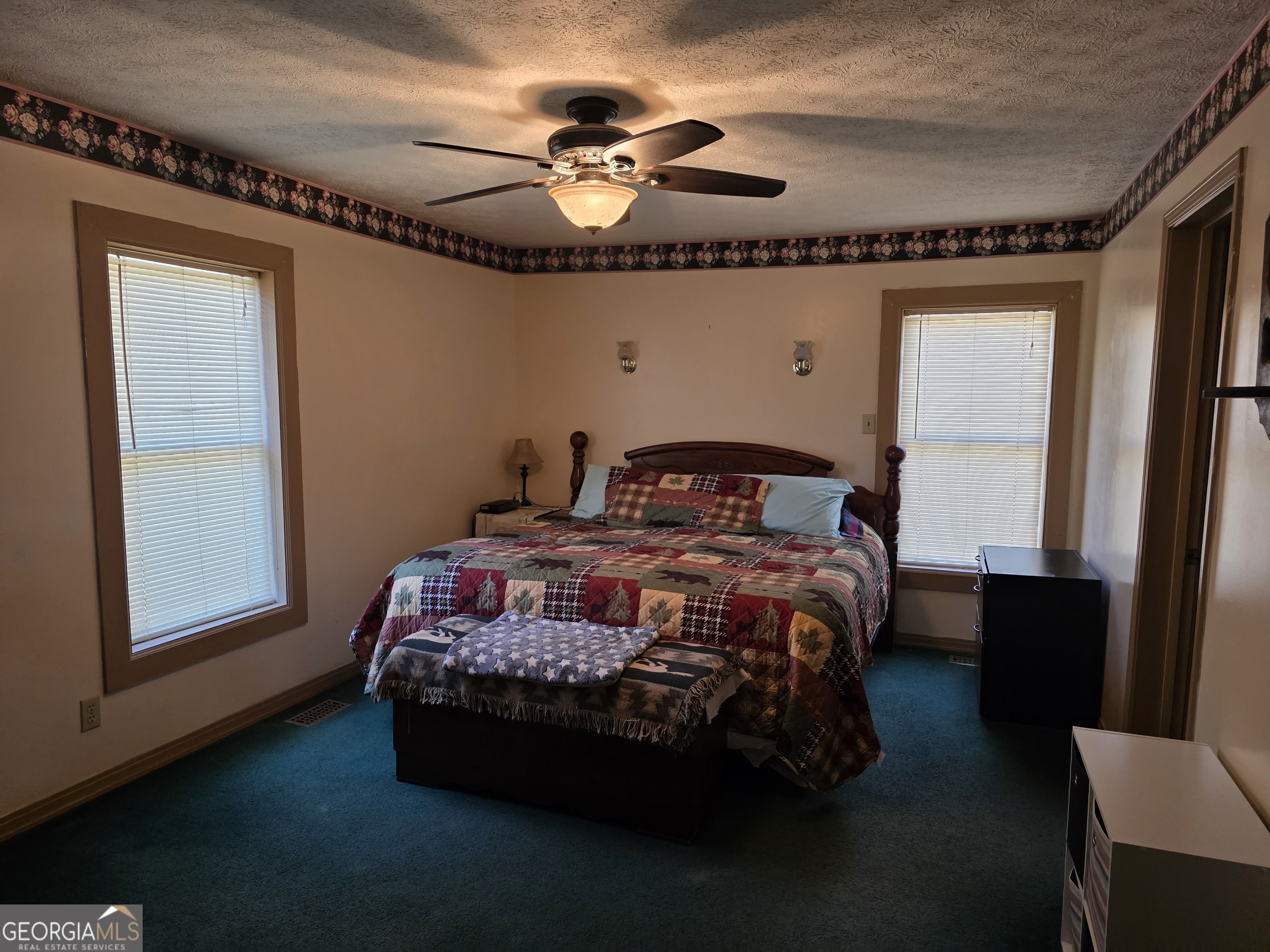 3879 Caney Head Road Roopville, GA 30217 - Photo 23 of 64 a bedroom with a bed and a chandelier