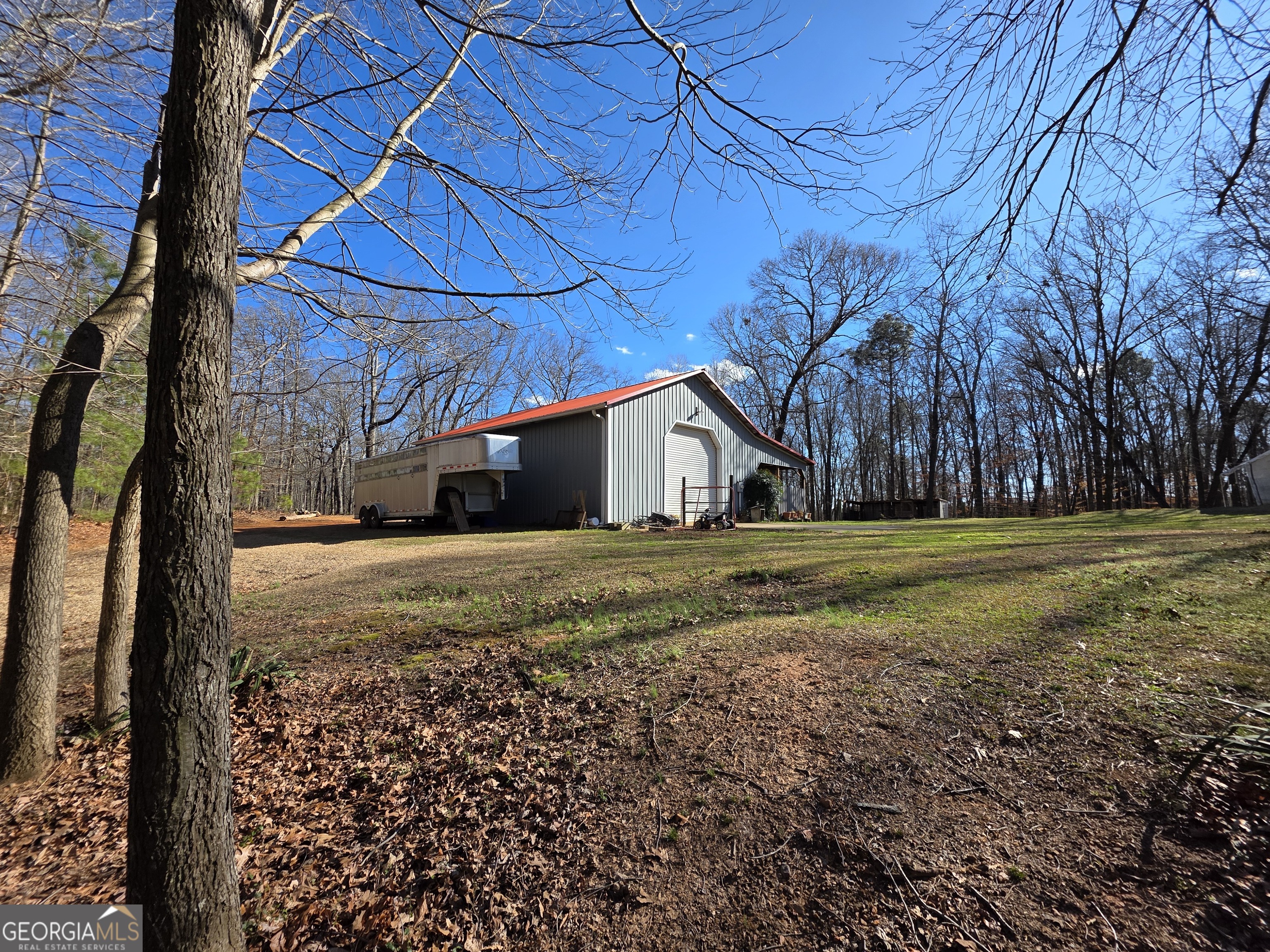 3879 Caney Head Road Roopville, GA 30217 - Photo 5 of 64 a view of a house with backyard and trees