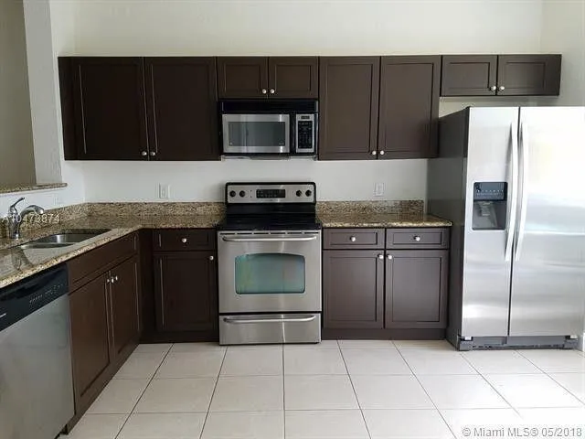 a kitchen with a sink a stove and refrigerator