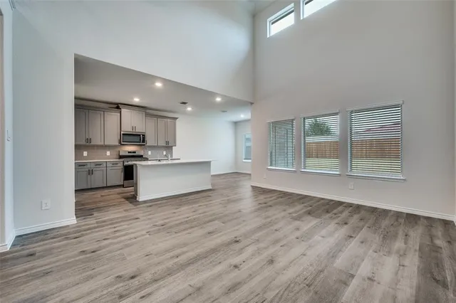 a view of kitchen with wooden floor and electronic appliances