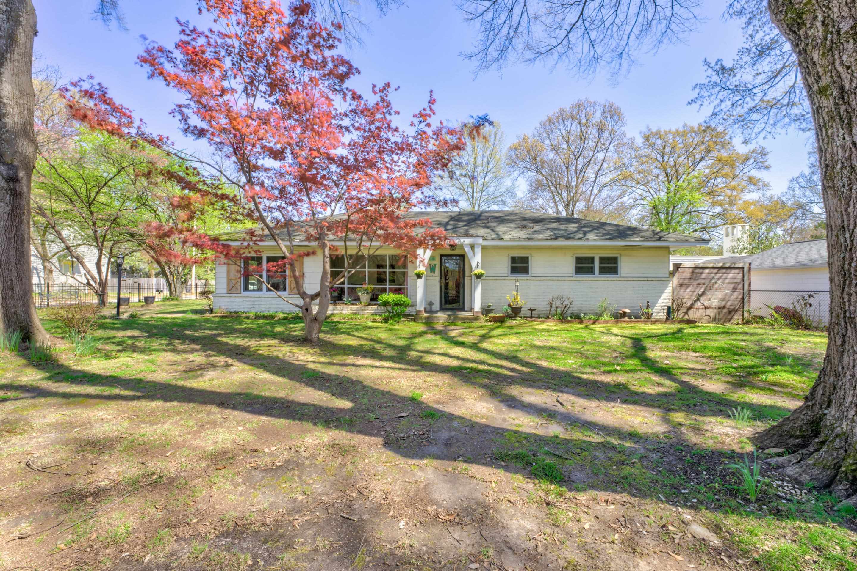 a view of a house with a yard and a garage