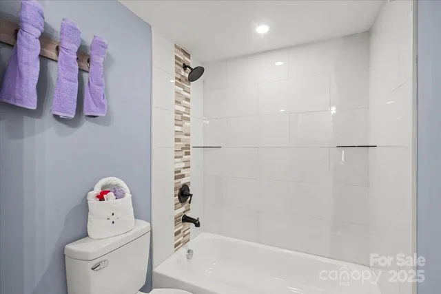 a bathroom with a shower a toilet and a shower curtain